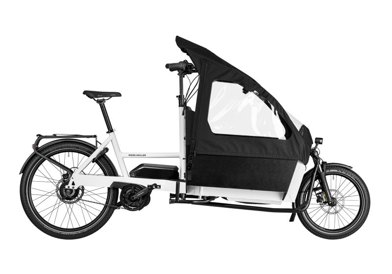 A white Riese and Muller Transporter2 65 vario cargo bike with child cover