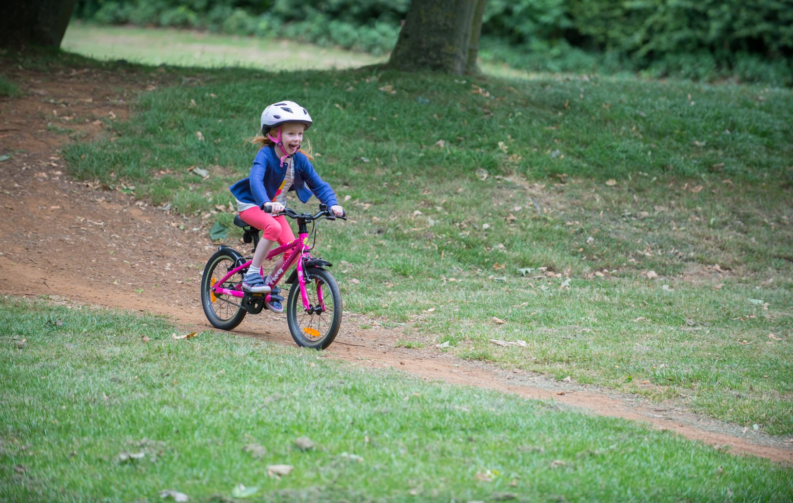 A girl riding a pink Frog 44 bike