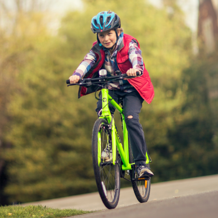 A boy riding a green Frog 67 bike