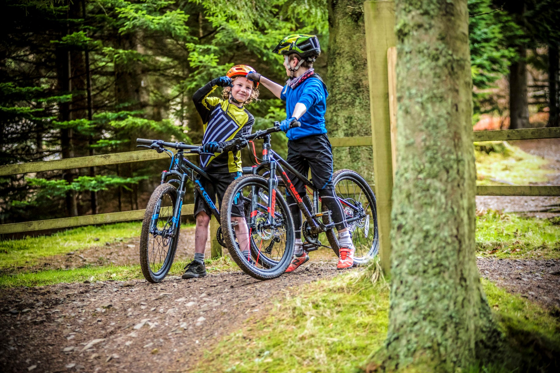 Two kids with Frog Mountain 62 bikes fist-bumping 