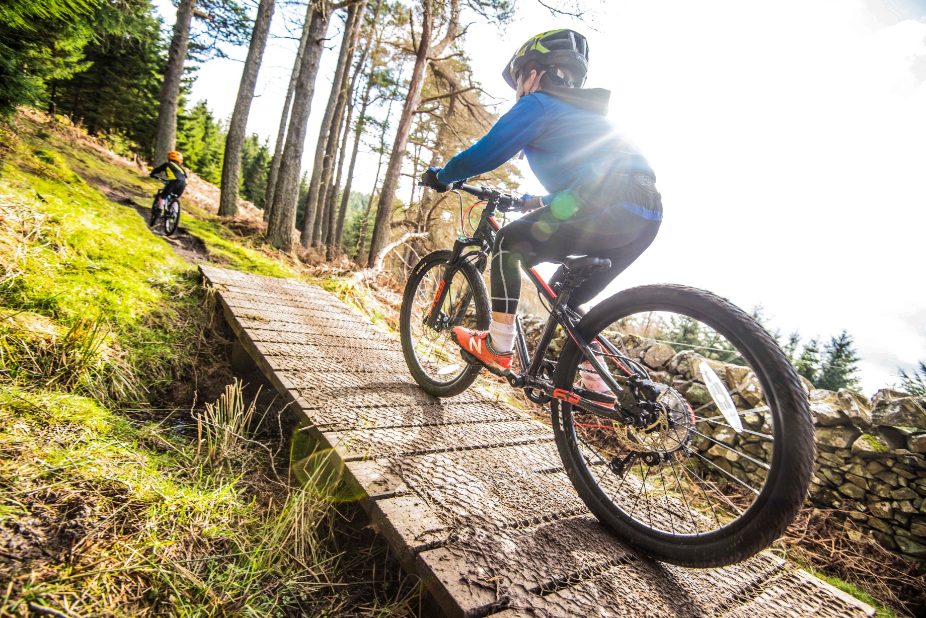 A kid riding up to a drop on a Frog Mountain 62 bike